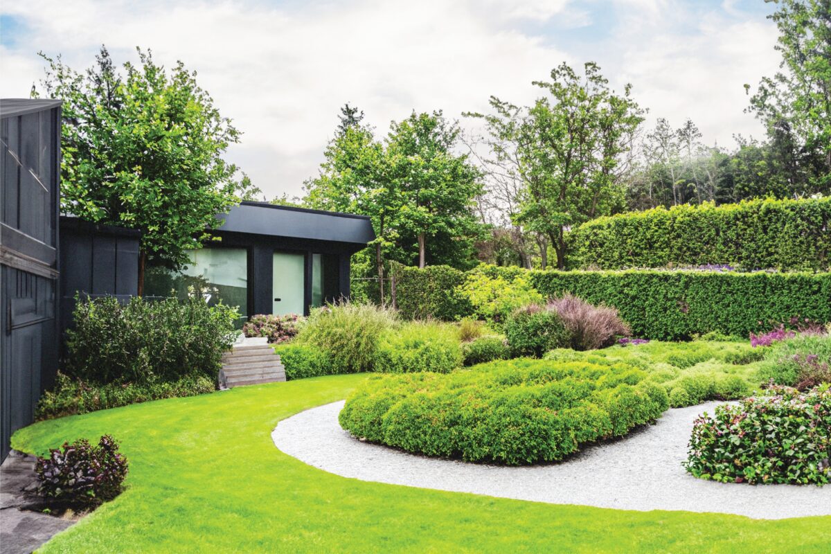Landscape design in Cohasset MA featuring custom patio stonework and coastal plantings by Land Design Associates