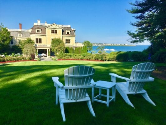Hardscaped front yard in Duxbury MA with natural stone walkway, retaining wall, and ornamental plantings by Land Design Associates