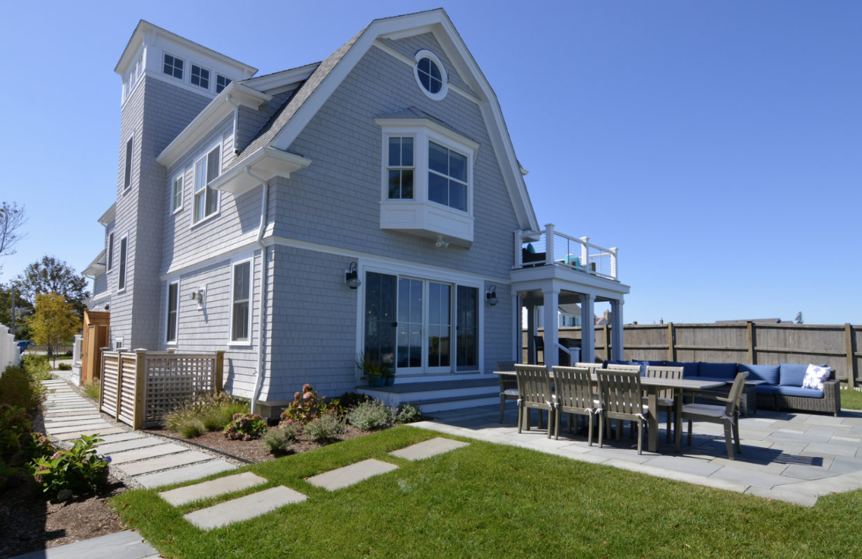 Complete new construction landscape installation with stone walkway, planted borders, and new lawn area designed by Land Design Associates for a new home in Duxbury MA
