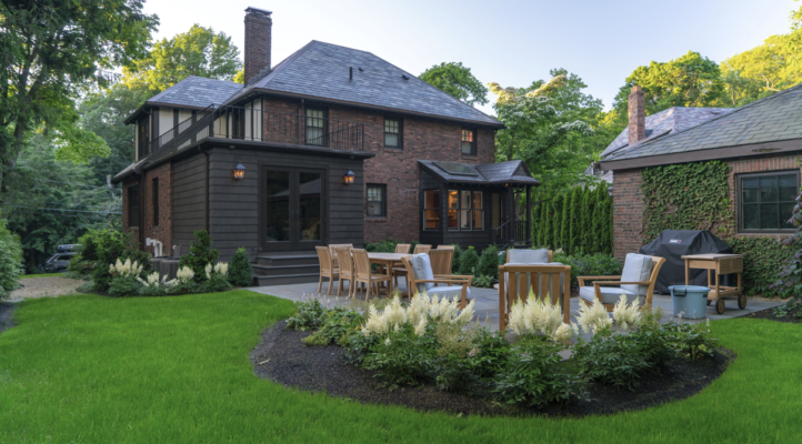 Homeowner and landscape contractor reviewing a site plan during a Massachusetts property evaluation