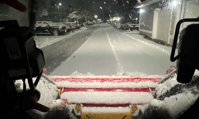 Commercial snow removal contractor documenting a cleared parking lot in Rhode Island