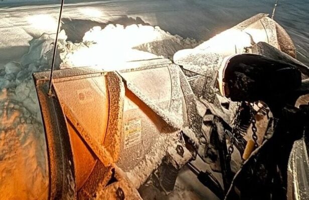 Property manager hiring a commercial snow removal contractor, meeting a Land Design Associates crew lead beside a plow truck in Walpole MA