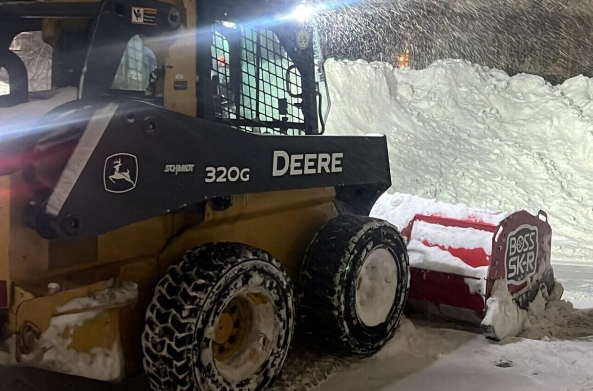 Land Design Associates plow truck clearing a commercial lot during a storm, for property managers switching snow removal contractors in Walpole MA
